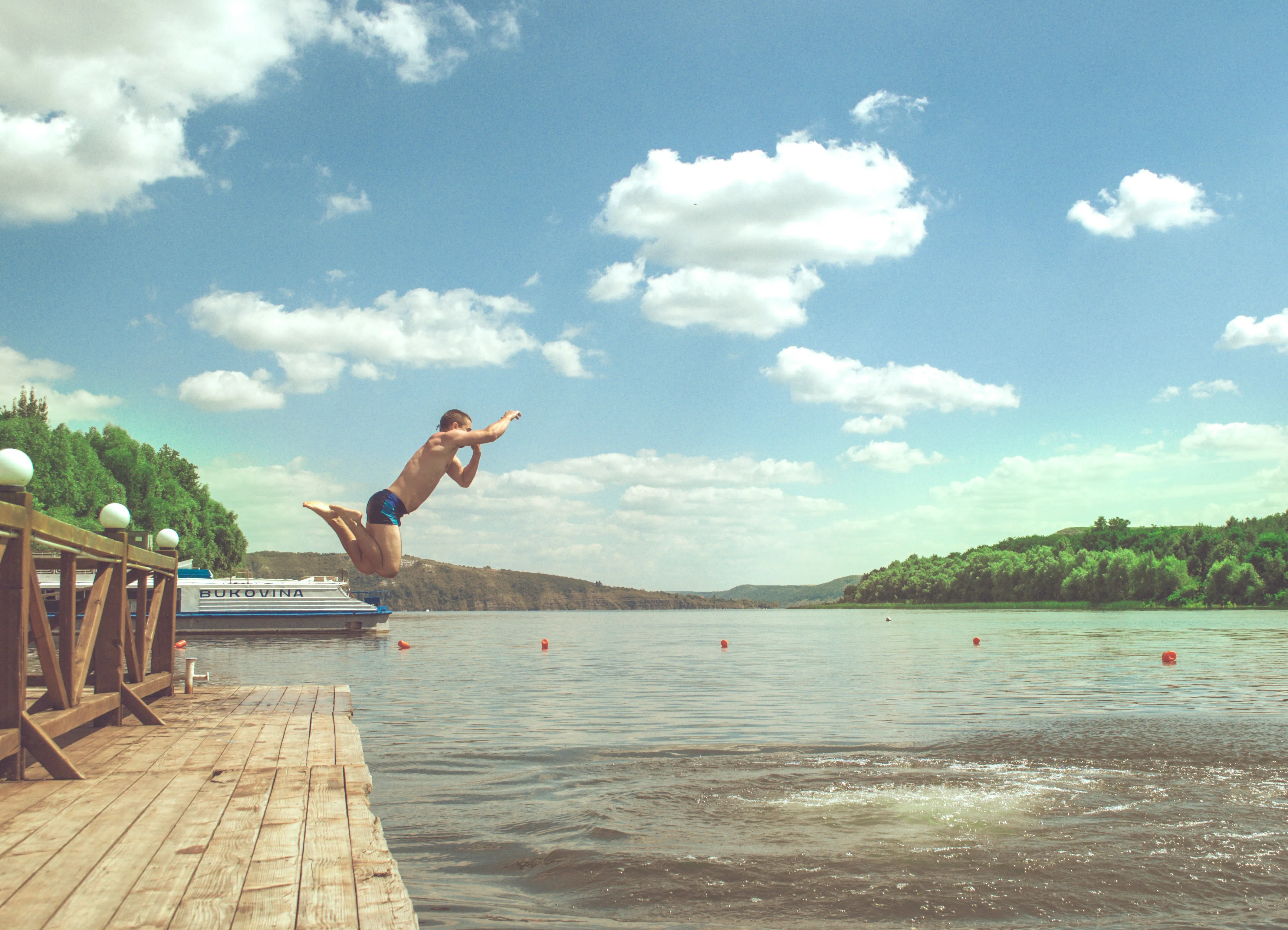A man diving into a lake